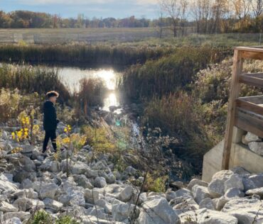 kid by river on trails