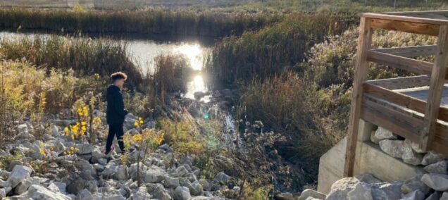 kid by river on trails