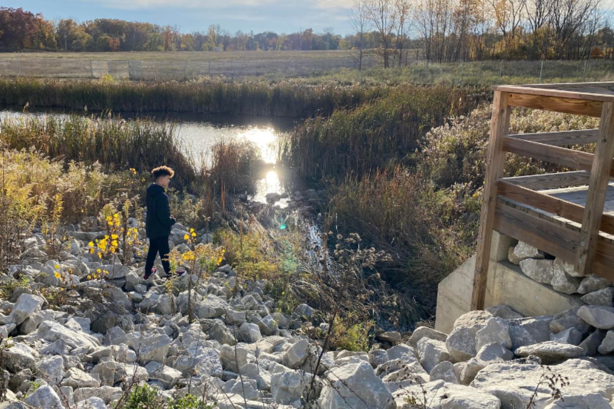 kid by river on trails