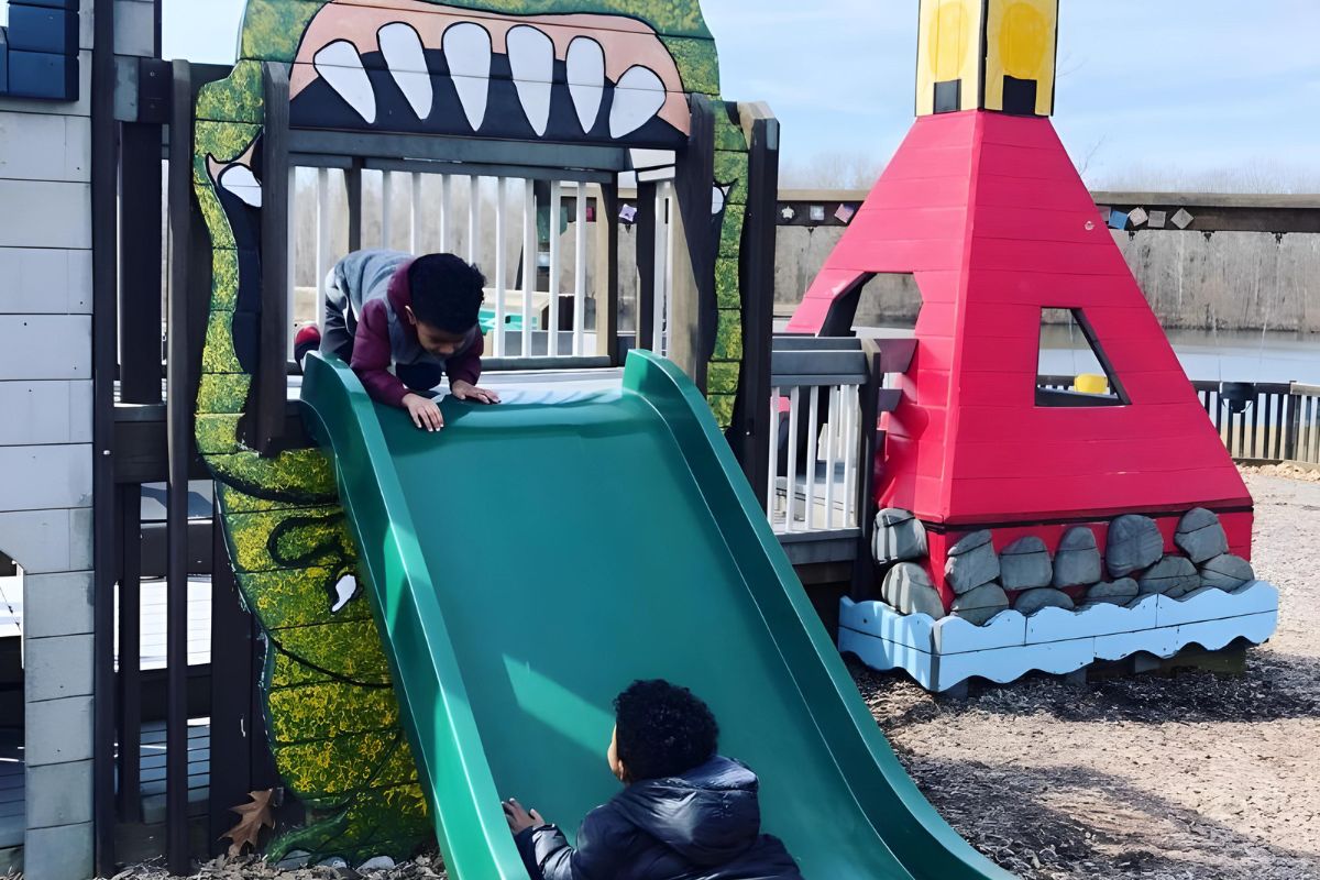 Hawk Island Lansing Park Playground boys on slide