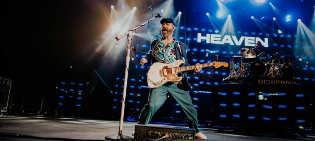 Unity Christian Music Festival Muskegon singer on stage with heaven sign fb