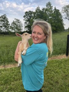 bluebird goat yoga holding goat