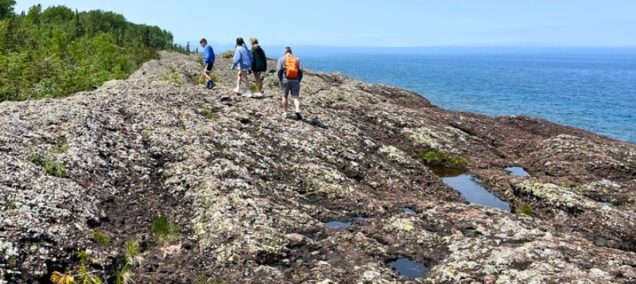 Family explores rocky cliffs on Lake Superior's Horseshoe Harbor, Copper Harbor, MI