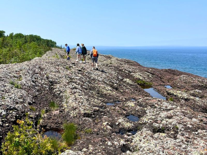Family explores rocky cliffs on Lake Superior's Horseshoe Harbor, Copper Harbor, MI