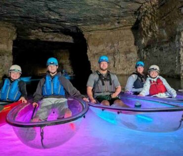 Four People In Kayaks Red River