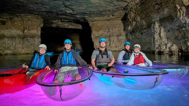 Four People In Kayaks Red River
