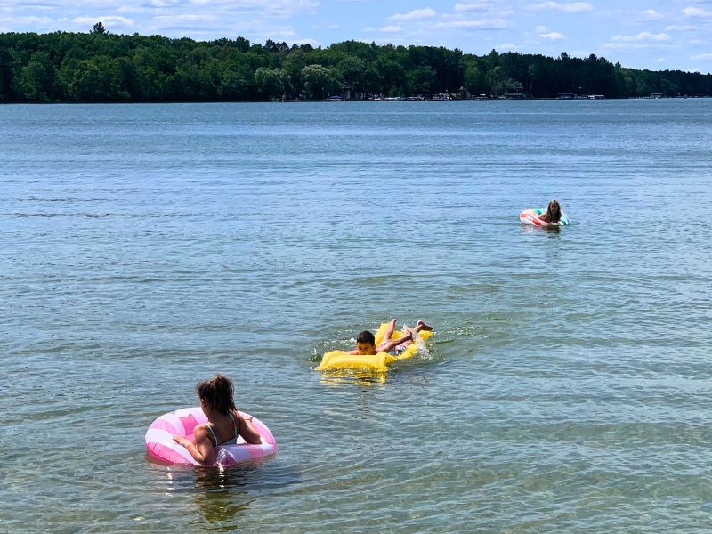 kids on rafts in lake